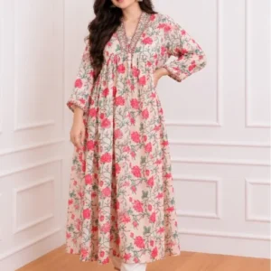 Woman wearing a cream kurta with pink and green floral print, mirror work V-neck and white pants, full-length front view